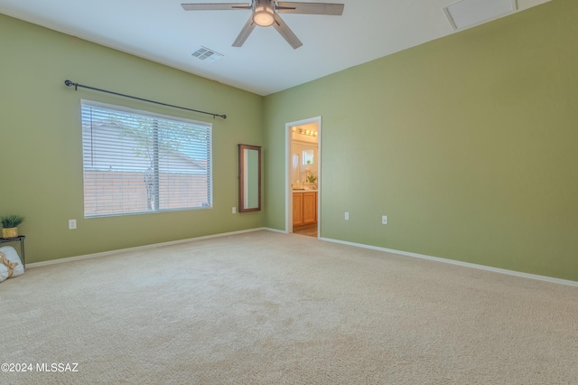 spare room featuring light carpet and ceiling fan