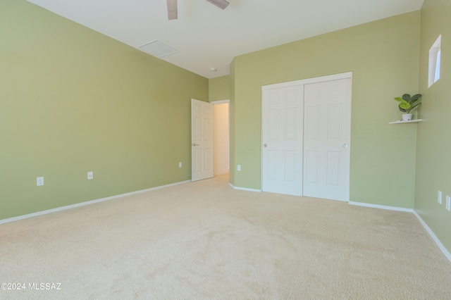 unfurnished bedroom featuring ceiling fan, carpet flooring, and a closet