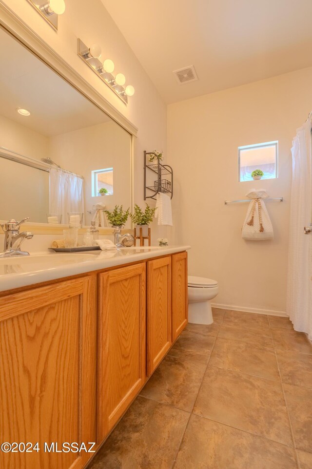 bathroom with vanity, tile patterned flooring, and toilet