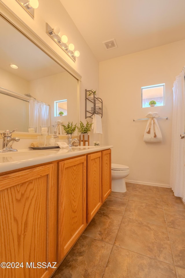 bathroom with tile patterned floors, vanity, and toilet