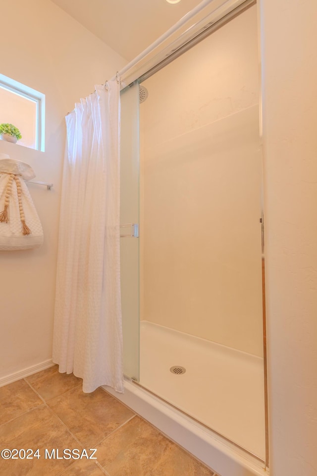 bathroom featuring walk in shower and tile patterned floors