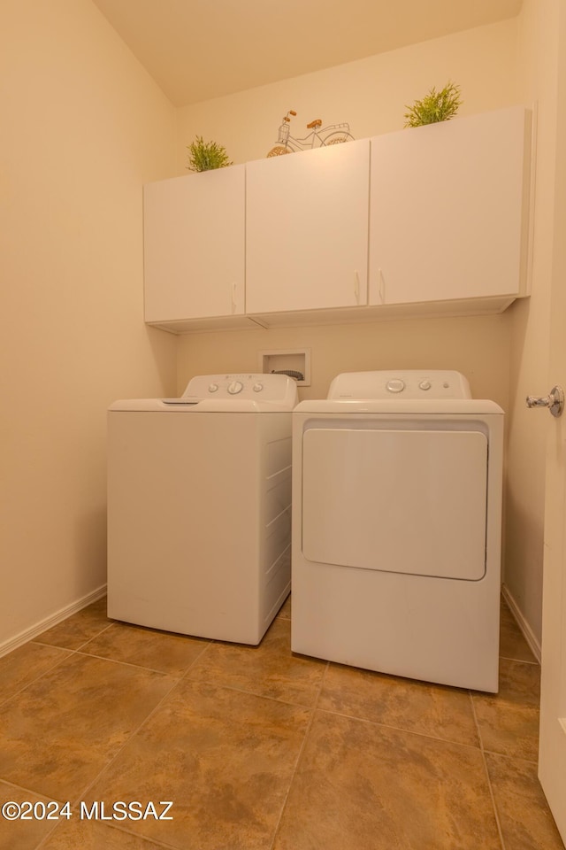 laundry room featuring cabinets and washer and dryer