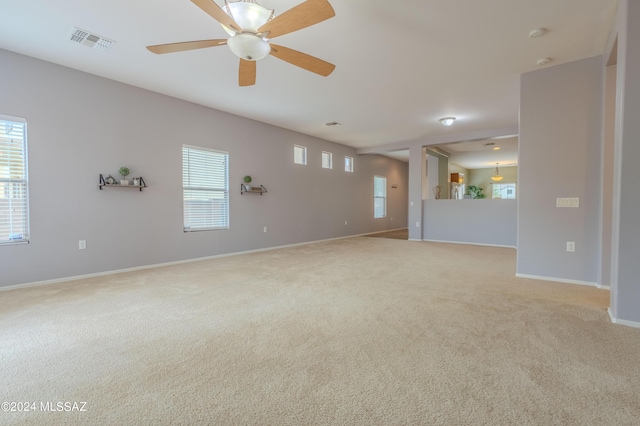 carpeted spare room with ceiling fan