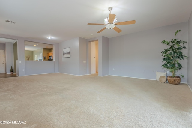 unfurnished living room featuring ceiling fan and carpet