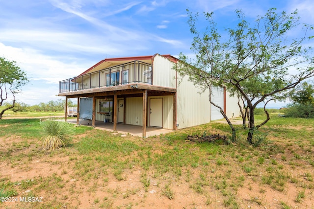 back of house with a patio area and a wooden deck