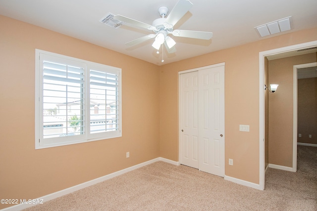 unfurnished bedroom featuring ceiling fan, carpet, and a closet