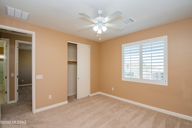 unfurnished bedroom featuring ceiling fan, a closet, and carpet flooring