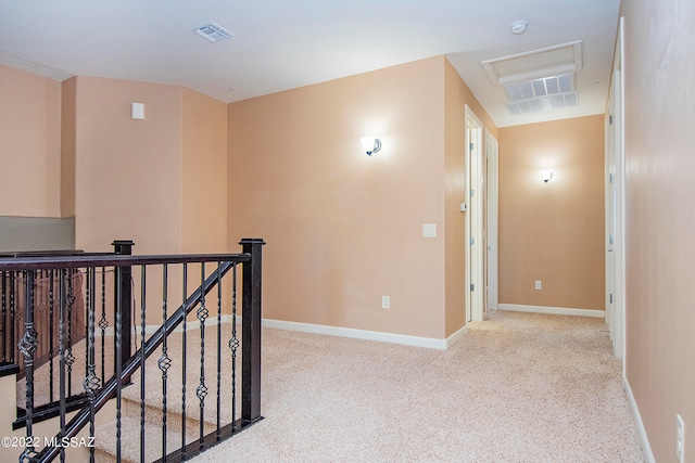 corridor featuring light colored carpet