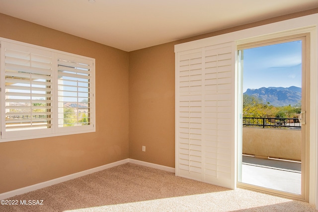 carpeted empty room with a mountain view