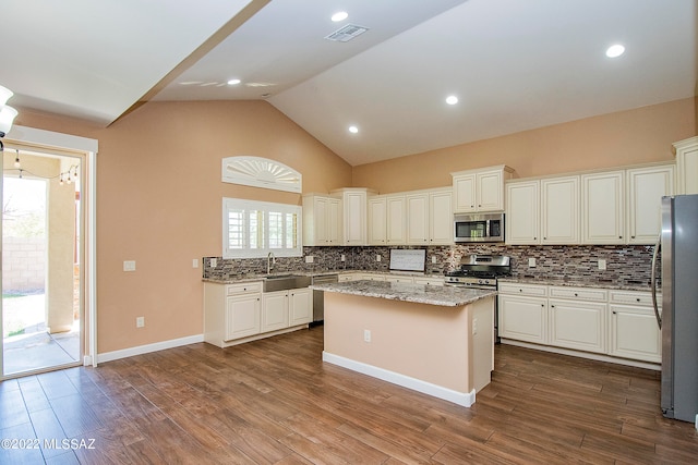 kitchen featuring backsplash, plenty of natural light, a center island, and stainless steel appliances