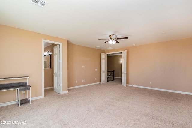 interior space featuring ceiling fan and light carpet