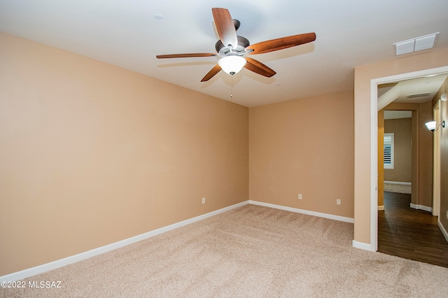 unfurnished room featuring light colored carpet and ceiling fan