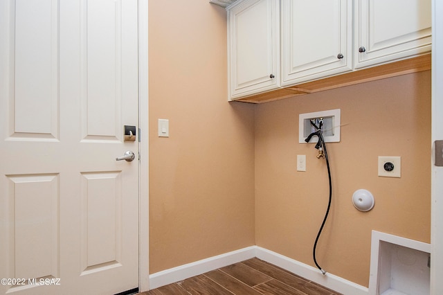 laundry area with hookup for a washing machine, dark wood-type flooring, electric dryer hookup, and cabinets