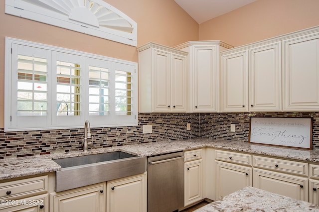 kitchen featuring tasteful backsplash, dishwasher, and a healthy amount of sunlight