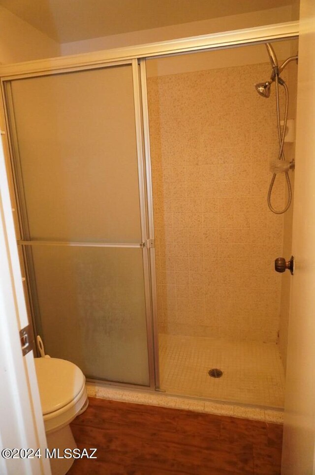 full bath with a shower stall and toilet