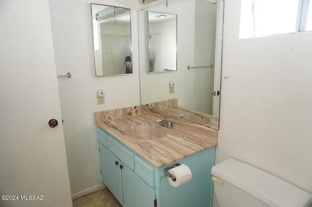 bathroom featuring toilet and vanity