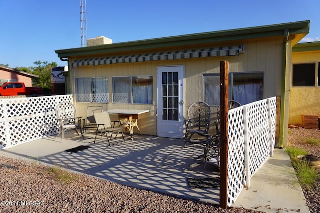 back of house featuring a patio and a chimney