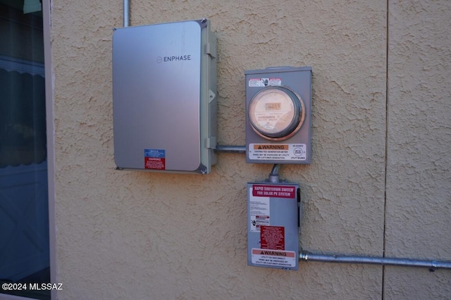 exterior details with stucco siding and electric meter