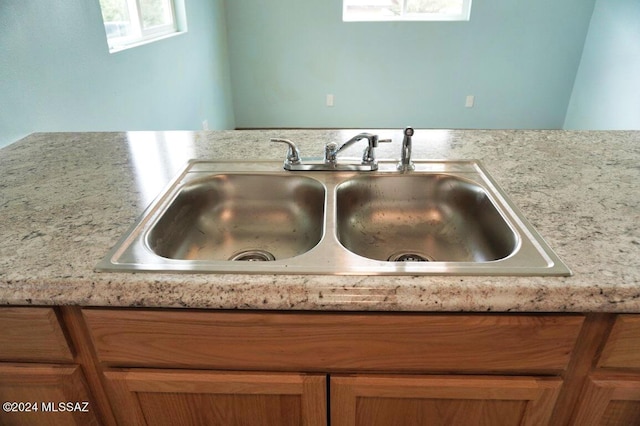 room details featuring brown cabinets and a sink
