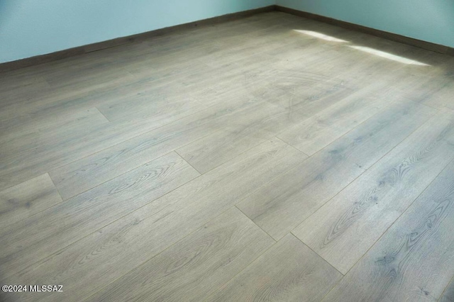 room details featuring baseboards and wood finished floors