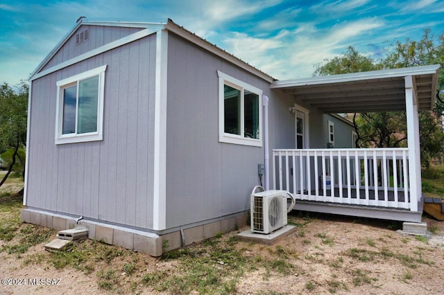 view of side of home with ac unit