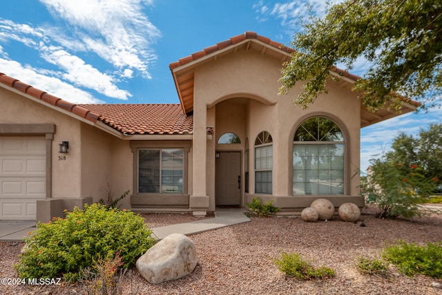 mediterranean / spanish-style home with a garage