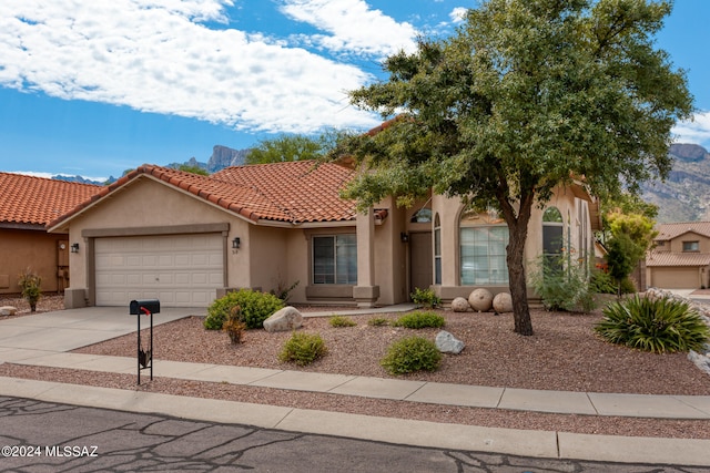 view of front of home featuring a garage and a mountain view