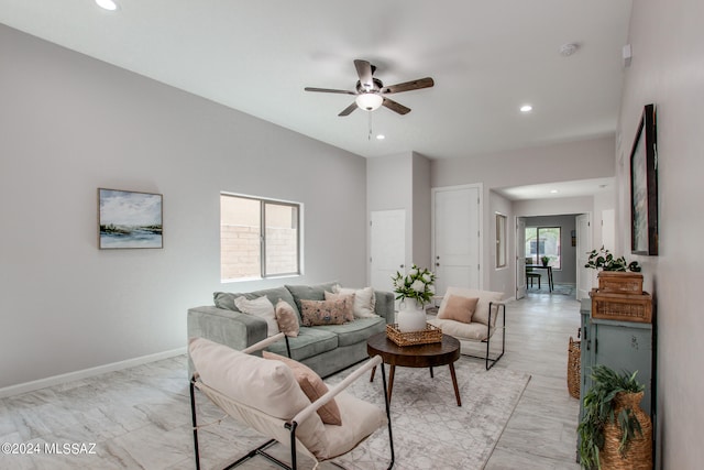 living room with a ceiling fan, recessed lighting, and baseboards