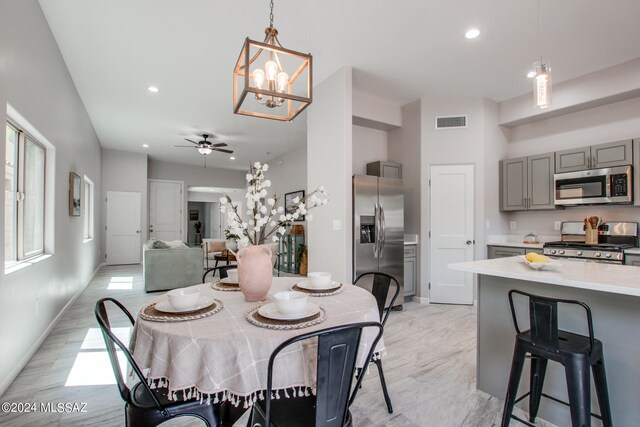 dining space with recessed lighting, visible vents, baseboards, and ceiling fan with notable chandelier