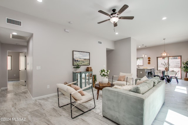 living room with a ceiling fan, recessed lighting, visible vents, and baseboards