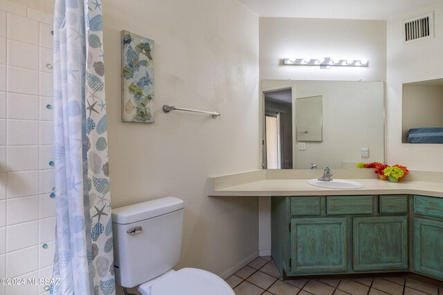 bathroom with tile patterned floors, vanity, toilet, and a shower with curtain