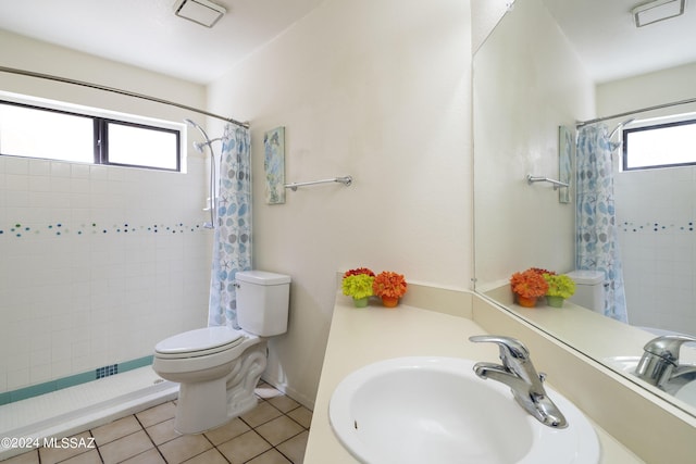 bathroom featuring tile patterned floors, walk in shower, a healthy amount of sunlight, and sink