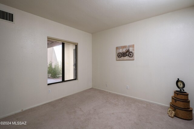 spare room with light colored carpet