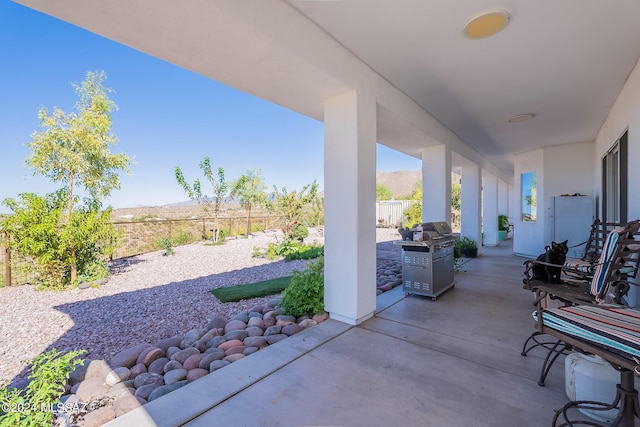 view of patio / terrace featuring fence