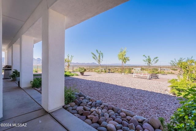 view of patio with a mountain view, area for grilling, and fence