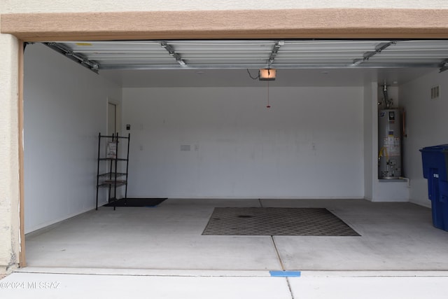 garage with water heater and a garage door opener