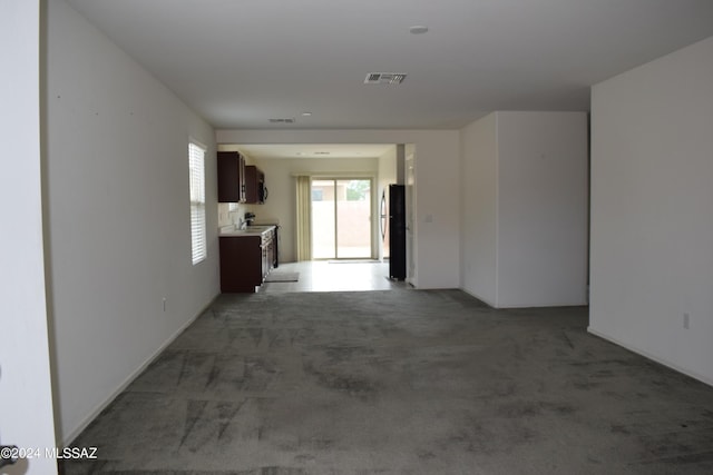 corridor with light carpet and visible vents