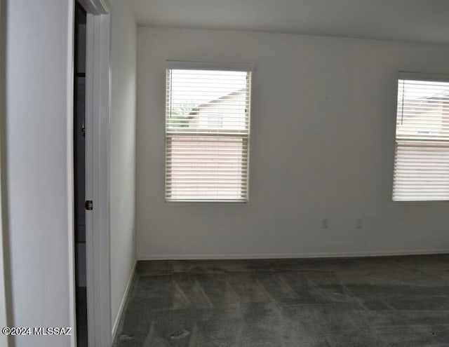 empty room featuring dark colored carpet