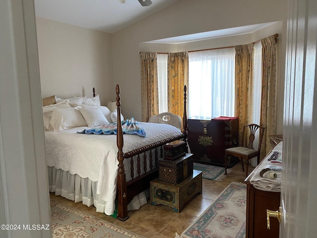 bedroom featuring vaulted ceiling and tile patterned floors