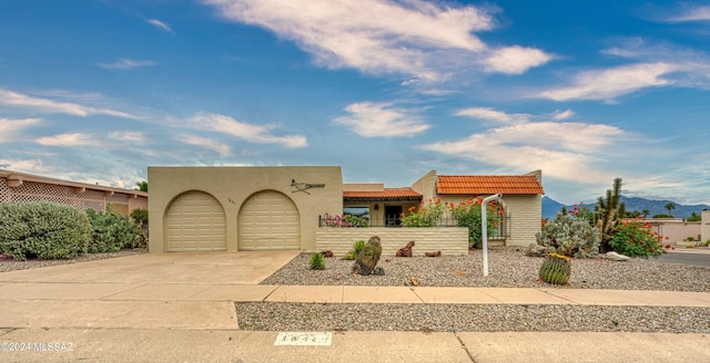 view of front of home featuring a garage and a mountain view