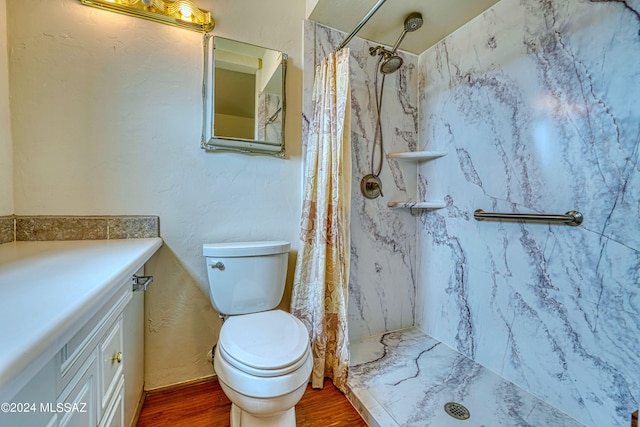 bathroom with a shower with shower curtain, wood-type flooring, vanity, and toilet