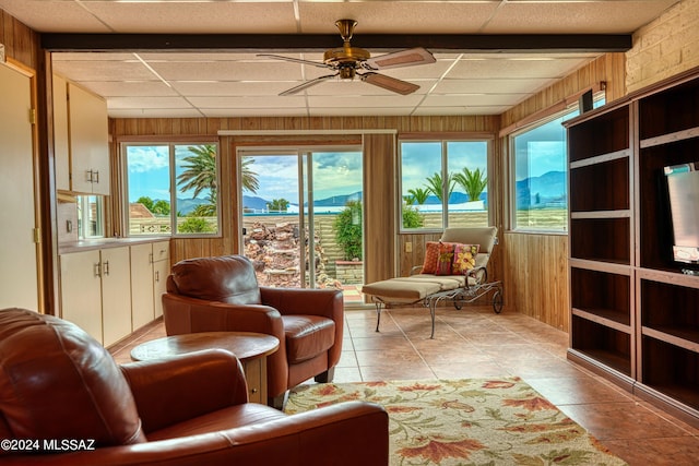 sunroom / solarium featuring ceiling fan