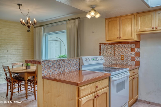 kitchen with tasteful backsplash, an inviting chandelier, electric stove, light tile patterned floors, and brick wall