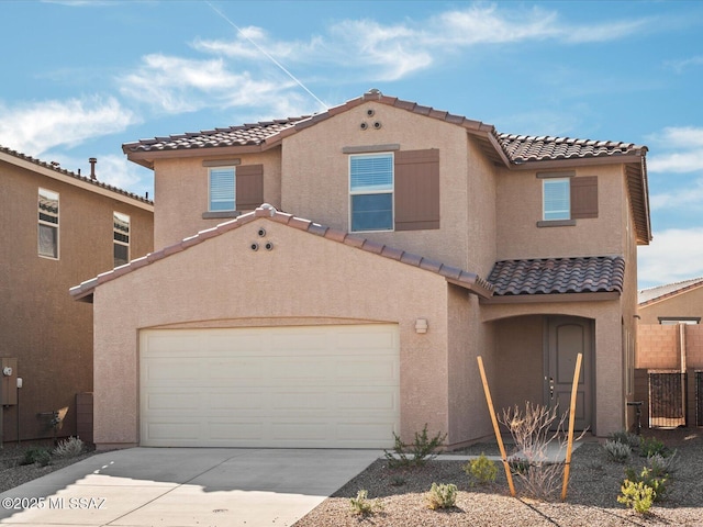 mediterranean / spanish-style house with stucco siding, driveway, fence, a garage, and a tiled roof