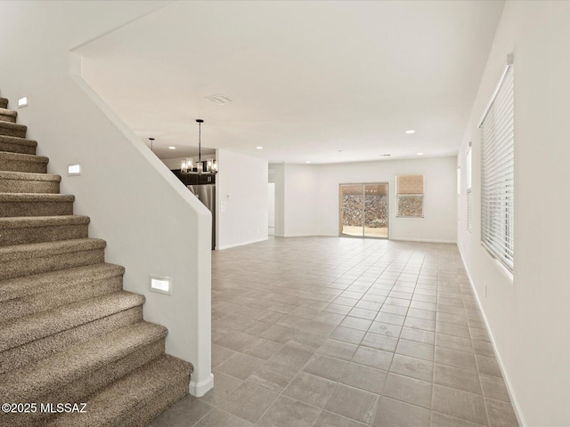 stairway featuring recessed lighting, baseboards, a notable chandelier, and tile patterned flooring