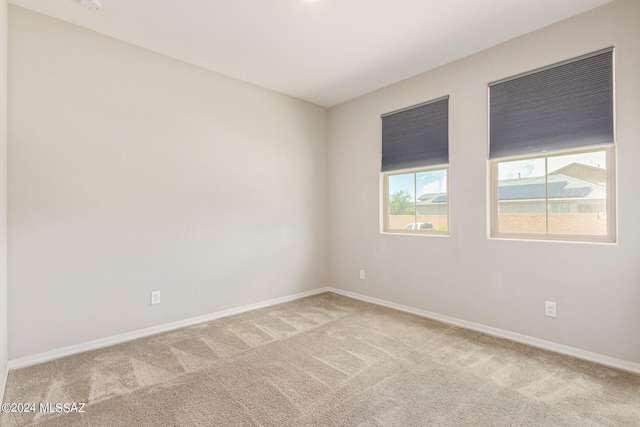 unfurnished room with light carpet