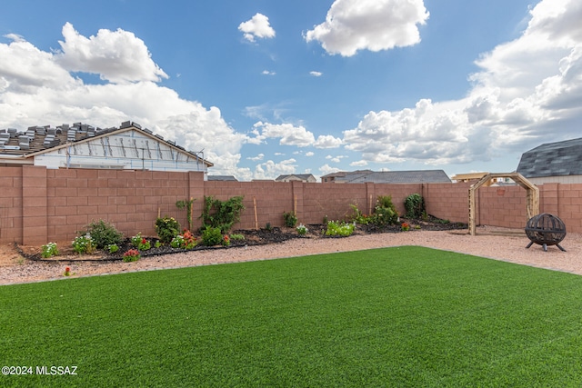 view of yard with a fire pit