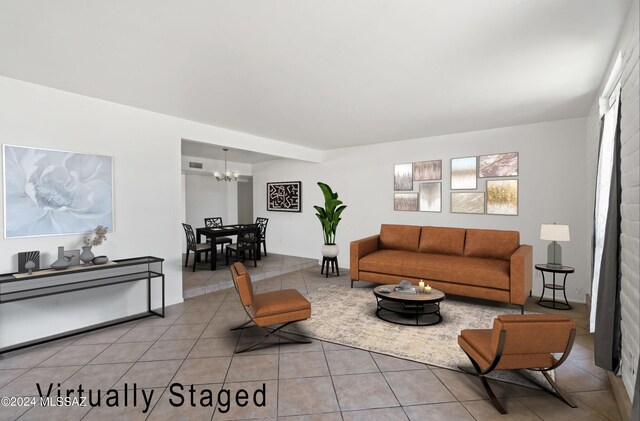 spare room featuring a notable chandelier and light tile patterned floors