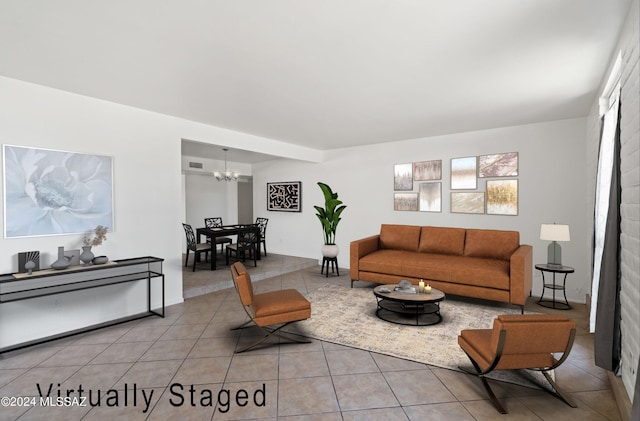 tiled living room featuring an inviting chandelier