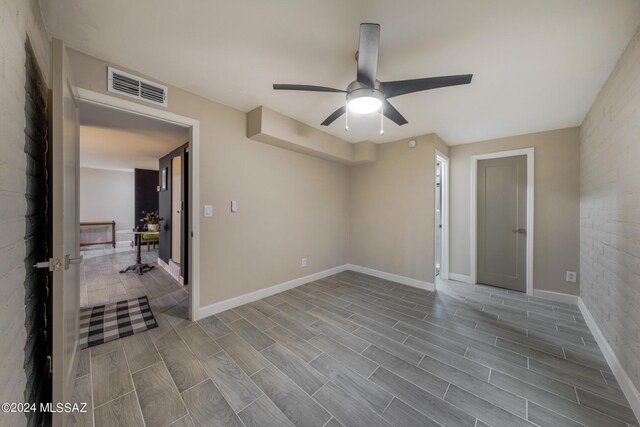 empty room featuring ceiling fan and light wood-type flooring